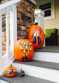 two pumpkins painted to look like children's pictures are sitting on the steps