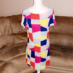 New Without Tags Never Been Worn. Tory Burch Mini Dress. Geometric Patterns Exterior. Short Sleeves. 100% Pima Cotton. Slip On No Zipper. Item#1814 33” Length 17” Chest Vibrant Multicolor Short Sleeve Mini Dress, Vibrant Fitted Dress With Short Sleeves, Multicolor Sheath Summer Dress, Chic Multicolor Print Short Sleeve Dress, Multicolor Shift Mini Dress With Short Sleeves, Spring Multicolor Sheath Mini Dress, Multicolor Sheath Mini Dress For Spring, Multicolor Summer Shift Dress, Summer Multicolor Shift Dress