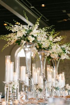 the centerpieces are filled with flowers and candles