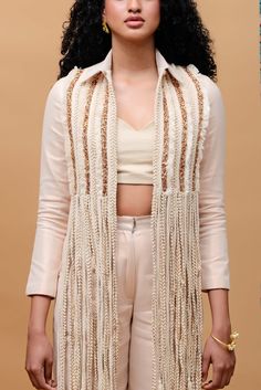 Editor's Note Featuring a rose gold jacket fully embellished with laces and details on back paired with ivory tube top and rose gold straight pants Color: Rose gold Fabric: Linen Occasion: Resort and party Components: Jacket, pant and tube top Disclaimer: Product color may slightly vary due to photographic lighting sources or your monitor setting. Care: Dry Clean Only About the Designer Rishi & Vibhuti label combines traditional elements with modern aesthetic uniquely to create chic occasion wea Braid Fringe, Rose Gold Jacket, Rose Gold Fabric, Stylish Crop Top, Latest Dress Design, Backstrap Loom, Gold Jacket, Fashion Top Outfits, Straight Fit Pants