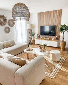 a living room filled with furniture and a flat screen tv on top of a wall