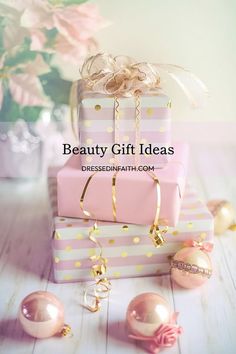 a stack of pink and gold wrapped presents on top of each other with the words, beauty gift ideas