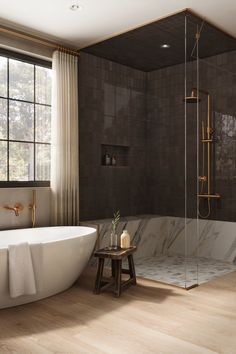 a bathroom with a tub, shower and wooden flooring in front of a large window