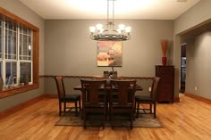 a dining room table with chairs and a chandelier