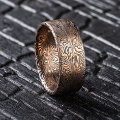 THIS RING IS CURRENTLY AVAILABLE IN STUDIO AND READY TO SHIP UPON PURCHASE!  This beautiful Mokume Gane ring is shown in a feather inspired pattern! Drawing from techniques used in making damascus patterns, Arn has been developing his own take on the style in mokume. The ring is made in our Firestorm palette, which features 14kt yellow gold, 14kt red gold, palladium and silver.  Size: 11 (please inquire if resize service is necessary) Pattern: Feather Palette: Firestorm Finish: Etched & Oxidized Profile: Flat Width: 9mm Please message us if you're interested in a custom ring quote! All of our rings are made from recycled precious metals and ethically sourced stones.  We ship internationally to most countries. Please inquire with us directly for international pricing.  For more information Hand Tooled Luxury Formal Jewelry, Luxury Hand Tooled Jewelry For Formal Occasions, Damascus Patterns, Mokume Gane Ring, Mokume Gane, Pattern Ring, Feather Pattern, Custom Ring, Mens Wedding Rings