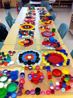 a long table with many different colored plates on it