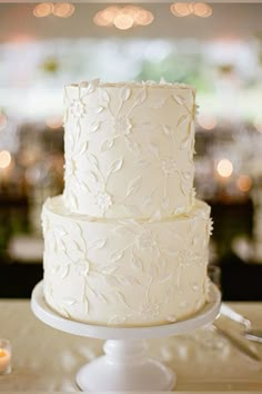 a white wedding cake sitting on top of a table