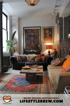 a living room filled with furniture and a chandelier hanging over the top of it