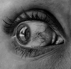 the eye of a woman with long lashes is shown in this black and white photo