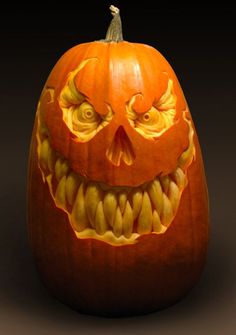 a carved pumpkin with an evil face on it