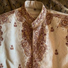 Size 40 Men’s Cream/Beige Sherwani With Bronze/Brown Embroidery. Great For A Groom Or Wedding Guest! There Are A Few Small Black Stains On The Inside Of The Jacket That Can Probably Be Spot Cleaned, No External Damage. No Rips, Tears, Or Other Stains. Only Worn Twice. Message Me For Further Info. Traditional Fit Sherwani With Intricate Embroidery For Diwali, Diwali Sherwani With Intricate Embroidery Traditional Fit, Traditional Fit Embroidered Bollywood Sherwani, Embroidered Bollywood Sherwani With Traditional Fit, Bollywood Style Embroidered Sherwani, Traditional Fit Sherwani With Intricate Embroidery For Festivals, Traditional Fit Sherwani With Zari Work For Ceremonies, Jamawar Kurta With Gold Embroidery For Festivals, Festivals Embroidered Traditional Fit Sherwani