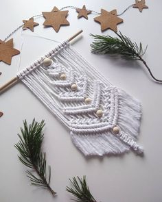 an ornament made out of string and wooden beads with stars on the side