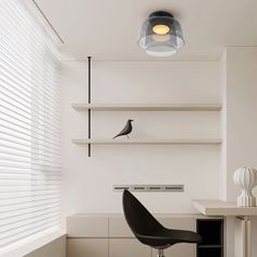 a black chair sitting in front of a white desk