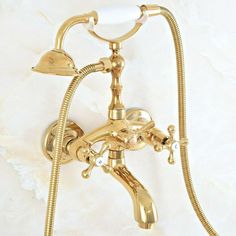 a gold shower faucet with two handset spouting water