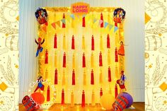 an image of a happy lohri birthday party backdrop with candles and decorations on the wall