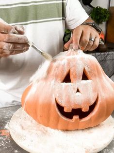 a person carving a pumpkin with a knife