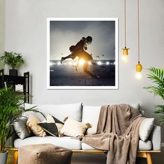 a living room with a white couch and a painting on the wall above it that shows a man skiing