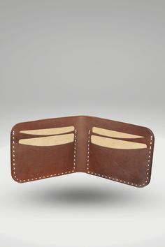 Men's Crazy Horse Dark Brown Genuine Cowhide Leather Wallet | Bifold Hand-Made Leather Wallet This men's crazy horse leather wallet is made from 100% Crazy Horse (Cowhide leather) and features a bi-fold design. The brown leather has been hand-sewn, waxed and burnished to give it a luxurious feel. It features one cash slot, four card pockets and a secured snap closure to keep your belongings securely held in place. Style: Standard Bi-Fold Wallet Made: Hand-stitched using waxed polyamide thread Leather: 100% Vegetable Tanned Crazy Horse (Cowhide leather) OuterShell Color: Dark Brown InnerShell Color: Dark Brown Thread: Off-White Closure: Bi-fold Feature: Crazy Horse Outer. (Inner natural mild), The edges are bevelle, waxed, and burnished for a finished look Weight: 70g Height 8 cm, width 11 Brown Bifold Wallet With Leather Patch, Brown Vegetable Tanned Leather Wallets For Everyday Use, Brown Vegetable Tanned Leather Wallet For Everyday Use, Brown Vegetable-tanned Leather Wallets For Everyday Use, Vegetable Tanned Leather Bifold Wallet For Everyday Use, Brown Leather Trifold Wallet With Waxed Finish, Leather Bifold Wallet With Waxed Finish, Brown Leather Wallet With Leather Patch, Brown Waxed Finish Wallets For Everyday Carry