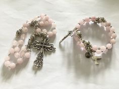 "Beautiful natural Rose Quartz Anglican prayer beads or full four week memory wire rosary bracelet You have a choice of the traditional rosary or the full four week memory wire rosary bracelet  Please select your choice from the options menu I have made this using rose Quartz beads, Tibetan silver beads,  Silver plated spacer beads, rhinestone spacers, Tibetan connecter, Tibetan cross and finished with silver tone wire work The rosary cross measures 2\", the bracelet cross measures 1.5\" Thank you for visiting my shop. If there is a particular piece you like but would prefer it in another colour, shortened or lengthened please contact me I can usually meet your requirements  A pretty silk brocade pouch is available for you to keep your item of jewellery or precious rosary in Please follow Silver Rosary Bracelet With Round Beads For Meditation, Pink Beaded Spiritual Rosary Bracelet, Spiritual Silver Beads Rosary Gift, Adjustable Silver Rosary For Meditation, Silver Rosary With Round Beads For Meditation, Elegant Pink Rosary Bracelet With Round Beads, Pink Bohemian Rosary Bracelet Gift, Adjustable Rose Gold Spiritual Rosary, Silver Beaded Rosary For Meditation