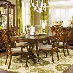 a dining room table with chairs and a china cabinet