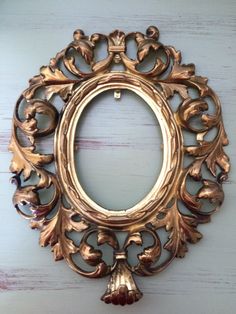 an ornate gold frame hanging on the wall