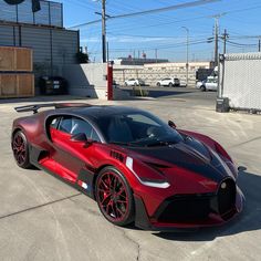 a red and black sports car parked in a parking lot