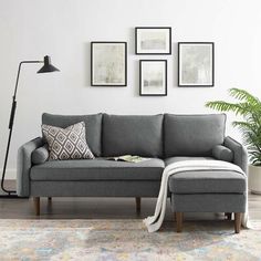 a living room with a gray couch and white rug