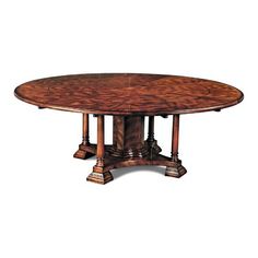 an oval dining table with four pedestals and two leaves on each end, in walnut