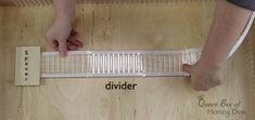 a person standing on top of a wooden floor next to a piece of paper that says divider