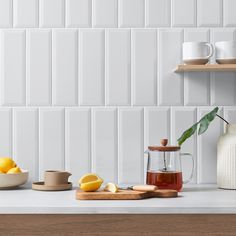 the kitchen counter is clean and ready to be used as a tea pot, lemons, and other items