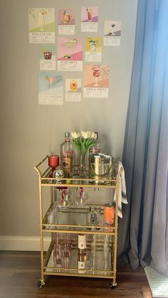 a gold bar cart with drinks on it