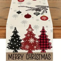 a christmas table runner with ornaments hanging from it's sides and the words merry christmas on