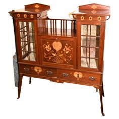 an old fashioned wooden cabinet with glass doors