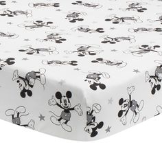 mickey mouse crib sheet with stars on the bottom and black and white print,