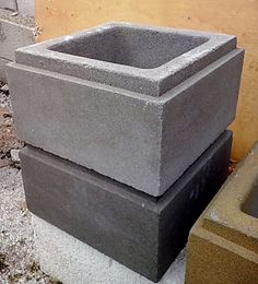 a concrete planter sitting on top of a cement block