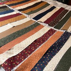 many different ties laid out on a table