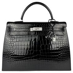 Up for sale is the Holy Grail Hermès Kelly 35 Diamond Black Shiny Crocodile. The Diamond Kelly is the pinnacle of luxury and elegance, celebrated as one of the rarest and most exquisite handbags in the world. Crafted from Porosus crocodile leather, the bag features a pearly black shine, that elevates this Diamond Kelly to a level of pure opulence is the dazzling hardware: the clasp, lock, and key are crafted from 18-karat white gold, and are adorned with sparkling, flawless diamonds. The combina Hermes Kelly 35, Hermes Kelly Pochette, Car Shoe, Prince Rainier, Flawless Diamond, Modernist Jewelry, Togo Leather, Kelly Bag, Jane Birkin