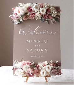 a welcome sign with flowers on it