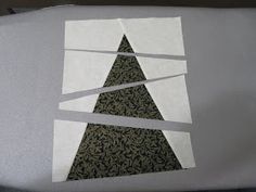 a piece of paper cut out to look like a christmas tree with white tape on it