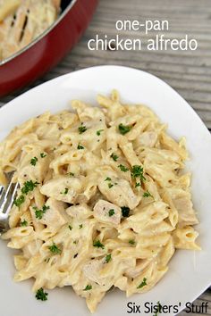 a white plate topped with pasta and chicken