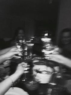 black and white photograph of people holding wine glasses