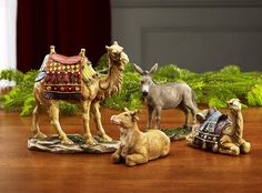 three figurines of animals sitting on a table