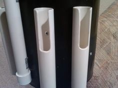 two white door handles on the side of a black and white wall mounted speaker system