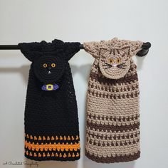 two crocheted cat bags hanging on a clothes line