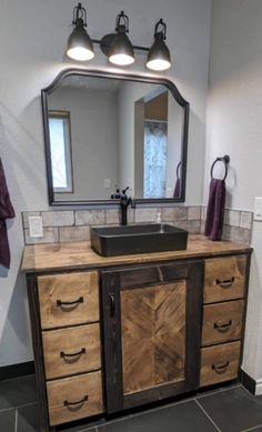 a bathroom with a sink, mirror and lights on the side of the counter top