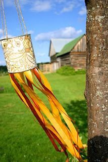 a wind chime hanging from the side of a tree