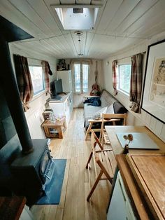 a living room filled with furniture and a wood stove top oven next to a window