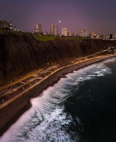 an aerial view of the ocean and coastline at night