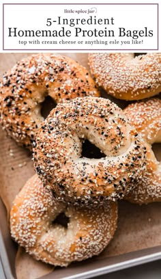 bagels with sesame seeds and poppy seed sprinkled on them in a tray