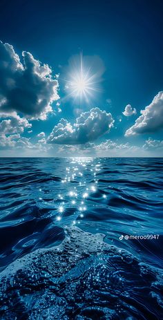 the sun shines brightly above the ocean as it reflects on the water's surface